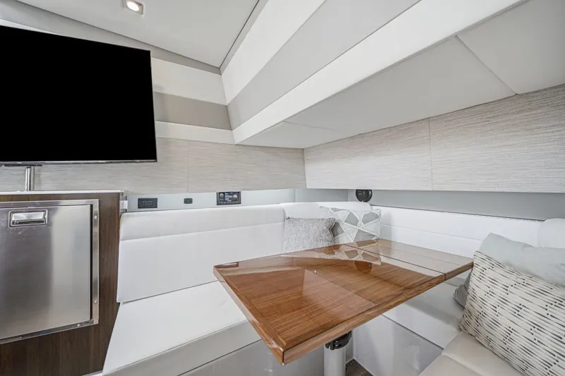 Slide: The Image of Interior of 2022 Cruisers Yachts 42 GLS I/O with modern seating and wooden table. - 32