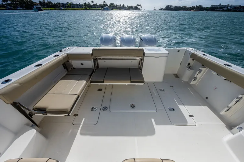 Slide: The Image of 2020 Pursuit OS 355 Offshore boat deck with seating, overlooking calm waters. - 42