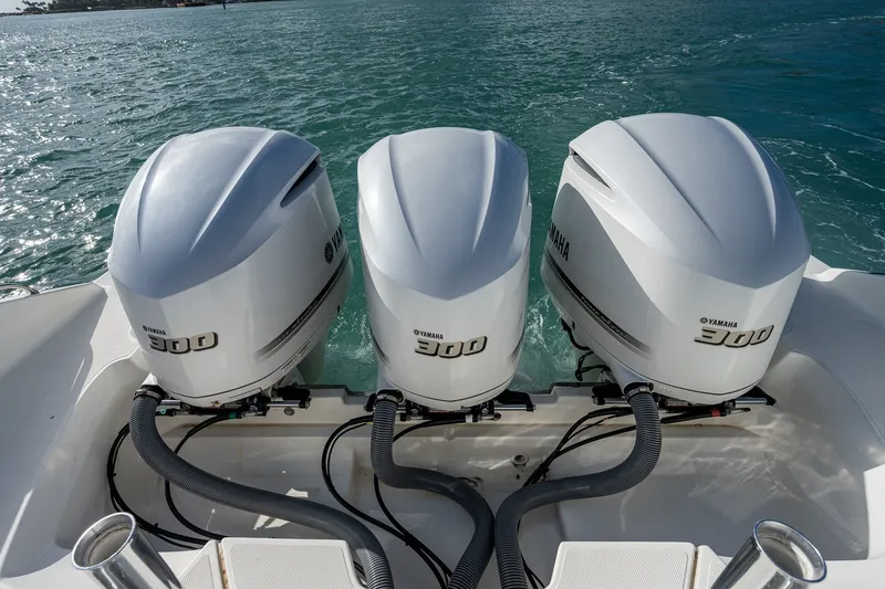 Slide: The Image of Triple Yamaha 300 engines on a 2020 Pursuit OS 355 Offshore boat. - 46