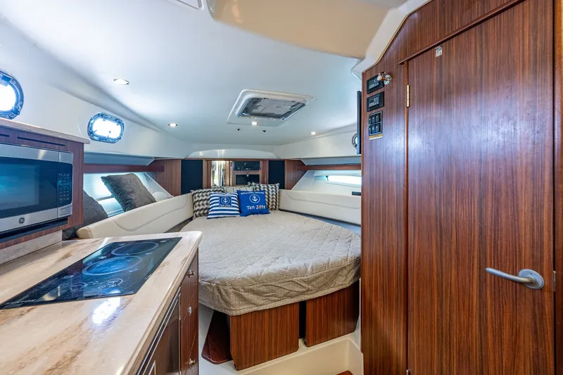 Slide: The Image of Luxurious interior of 2020 Pursuit OS 355 Offshore boat with cozy bed and kitchenette. - 51