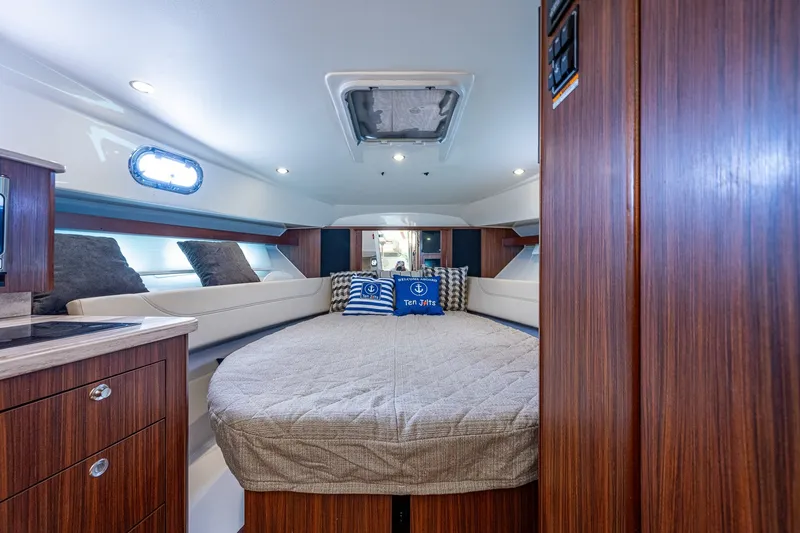 Slide: The Image of Luxurious cabin interior of 2020 Pursuit OS 355 Offshore boat with cozy bedding. - 52