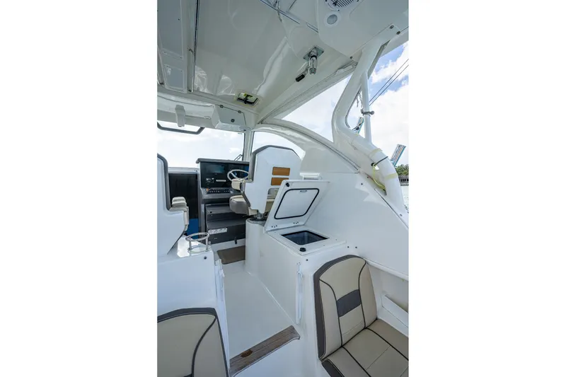 Slide: The Image of 2020 Pursuit OS 355 Offshore boat interior with helm and seating area. - 31