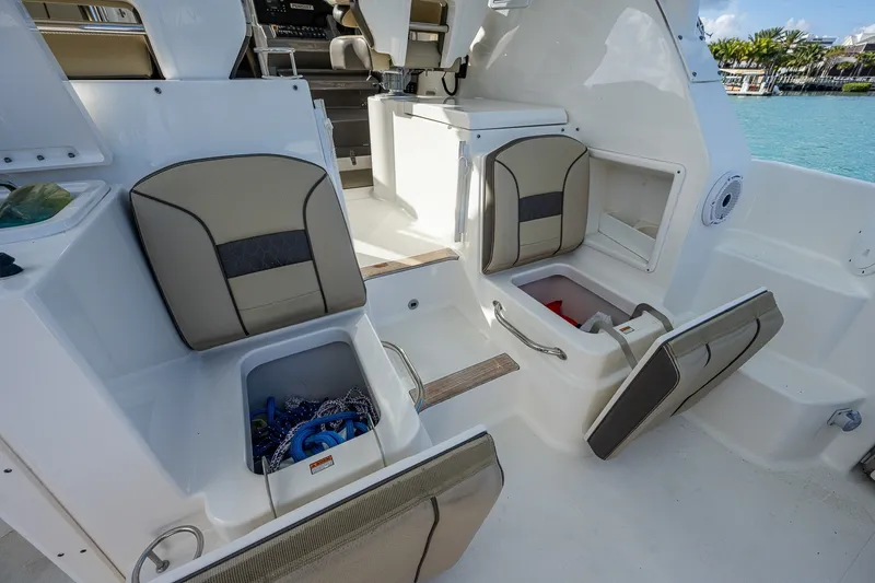 Slide: The Image of 2020 Pursuit OS 355 Offshore boat interior with open storage compartments and seating. - 34