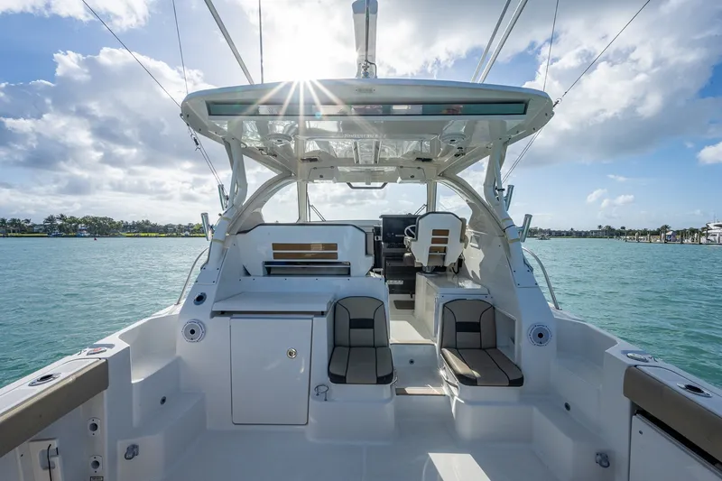 Slide: The Image of 2020 Pursuit OS 355 Offshore boat interior with seating, helm, and ocean view. - 32