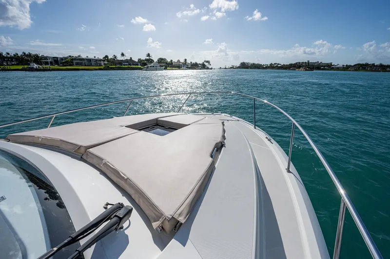 Slide: The Image of 2020 Pursuit OS 355 Offshore boat cruising on a sunny day, with scenic waterfront views. - 48