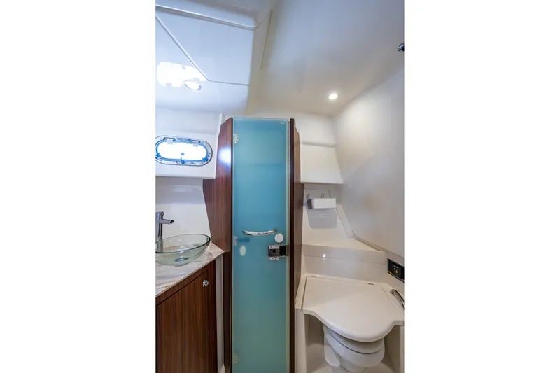 Slide: The Image of 2020 Pursuit OS 355 Offshore yacht bathroom with modern fixtures and frosted glass door. - 59