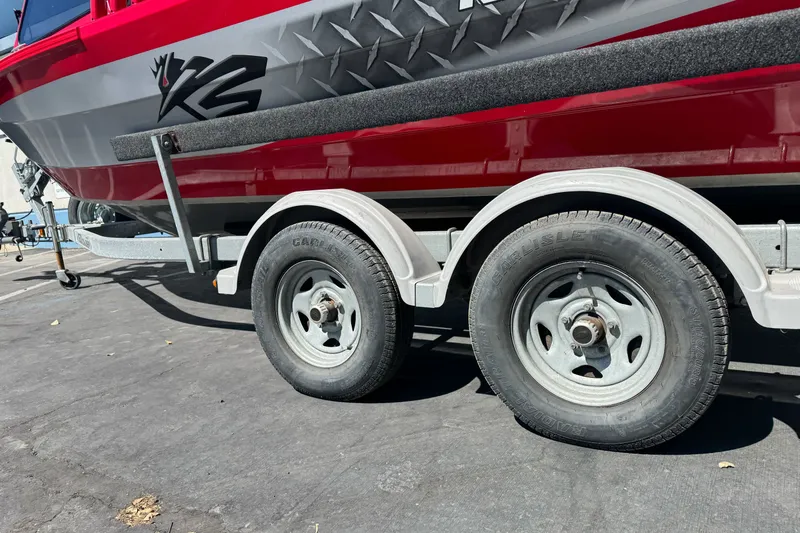 Slide: The Image of Red KingFisher 2025 Discovery boat on trailer, showcasing dual wheels, 2016 model. - 10