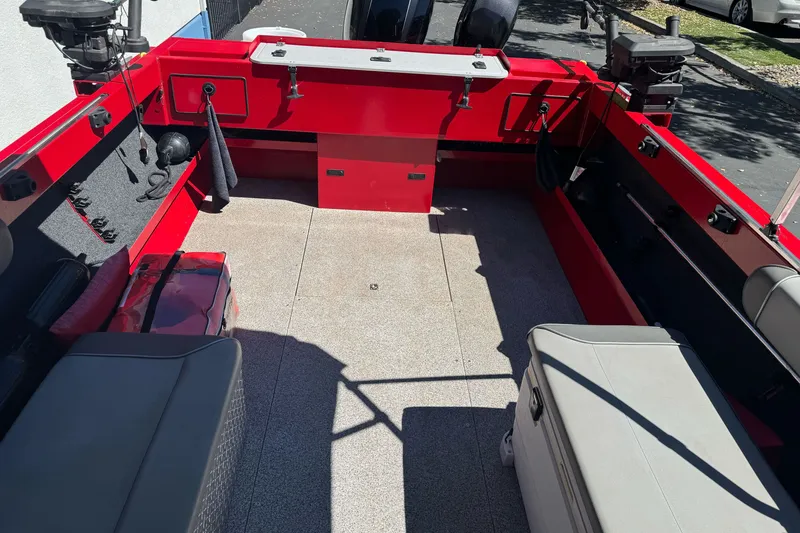 Slide: The Image of Red KingFisher 2025 Discovery boat interior, 2016 model, with seating and storage compartments. - 22