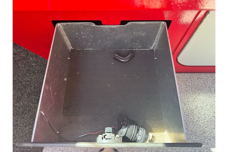 Slide: The Image of Storage compartment in a 2016 KingFisher 2025 Discovery boat, featuring a black interior. - 20