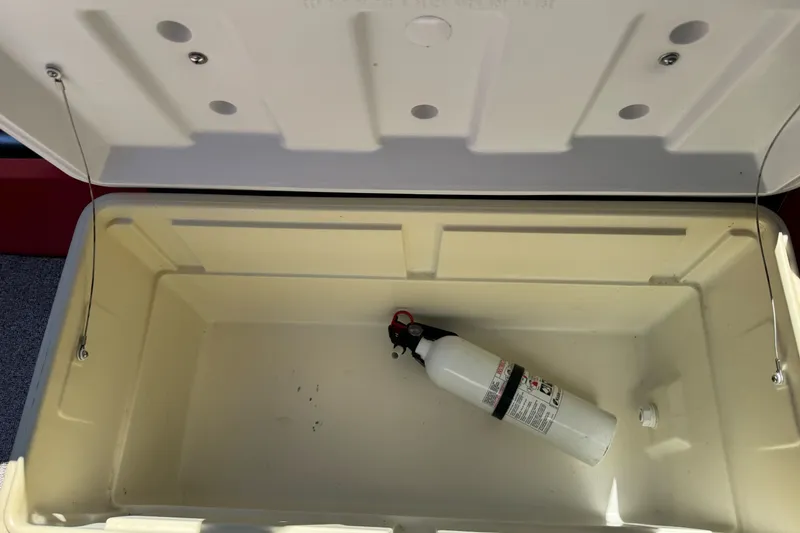 Slide: The Image of Open storage compartment with fire extinguisher in KingFisher 2025 Discovery boat, 2016 model. - 24