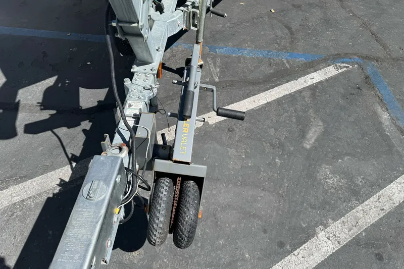 Slide: The Image of Trailer hitch with manual mover on a KingFisher 2025 Discovery, 2016 model, in a parking lot. - 3