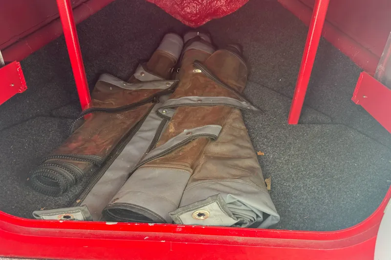 Slide: The Image of Storage compartment of a 2016 KingFisher 2025 Discovery boat with rolled-up covers. - 18