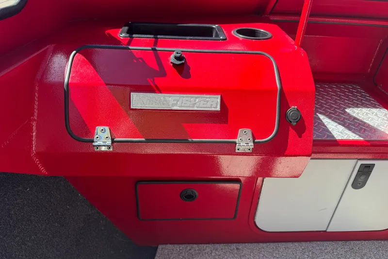 Slide: The Image of Red KingFisher 2025 Discovery boat interior, featuring storage compartments and cup holders. - 19