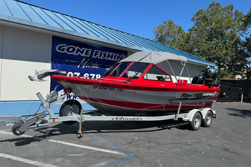 Slide: The Image of Red 2016 KingFisher 2025 Discovery boat on trailer outside Gone Fishing Marine. - 1