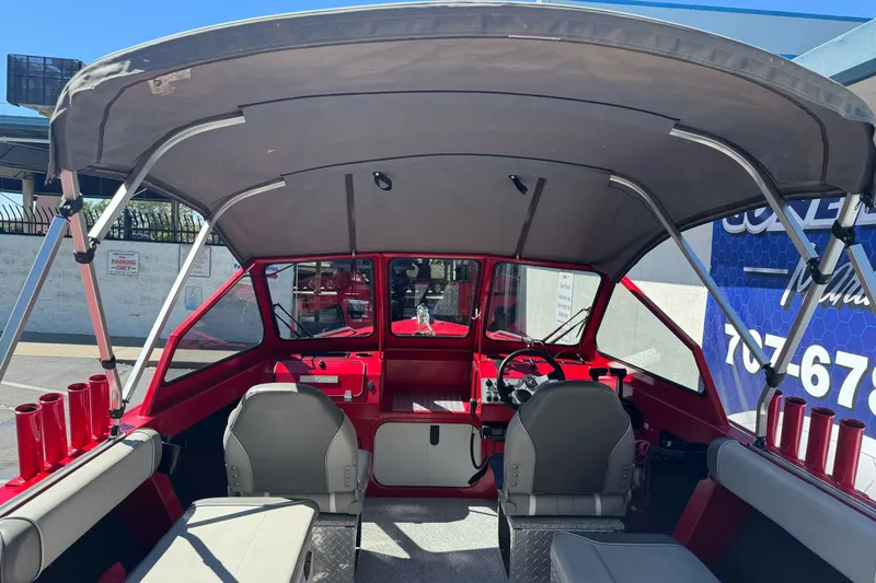 Slide: The Image of Interior view of a 2016 KingFisher 2025 Discovery boat with seating and canopy. - 12