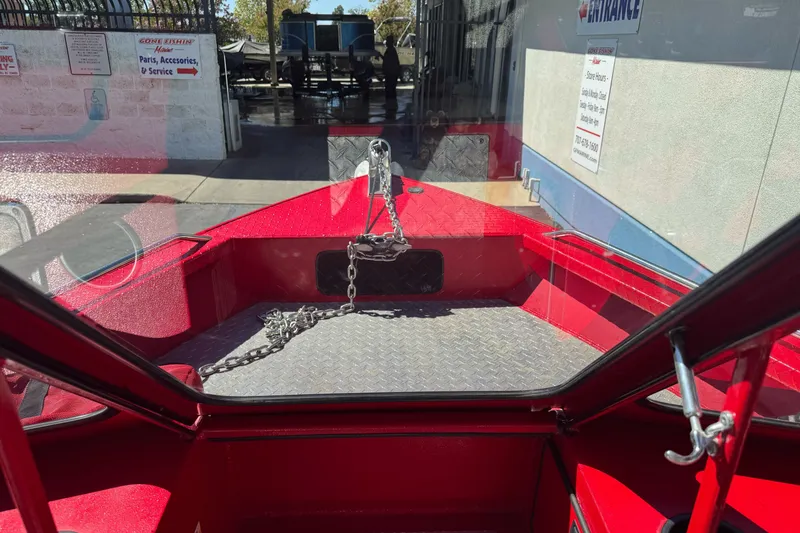 Slide: The Image of Red KingFisher 2025 Discovery boat interior with chain, parked at service center. - 14