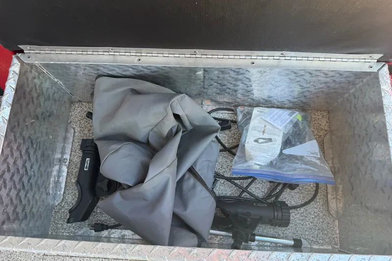 Slide: The Image of Storage compartment of a 2016 KingFisher 2025 Discovery boat with tools and accessories. - 23