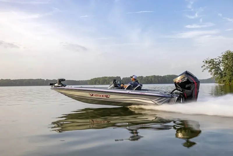 The Image of 2026 Phoenix 819 ZXL boat speeding on a calm lake under a clear sky. - 1