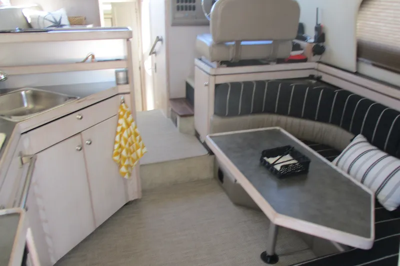Slide: The Image of Interior of 1995 Bayliner 3258 Avanti boat with kitchenette and seating area. - 24