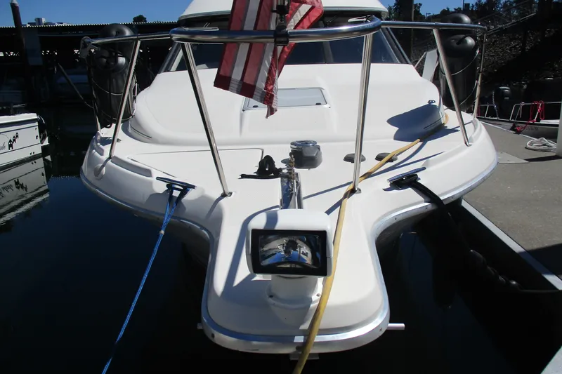 Slide: The Image of 1995 Bayliner 3258 Avanti boat docked with American flag displayed. - 3