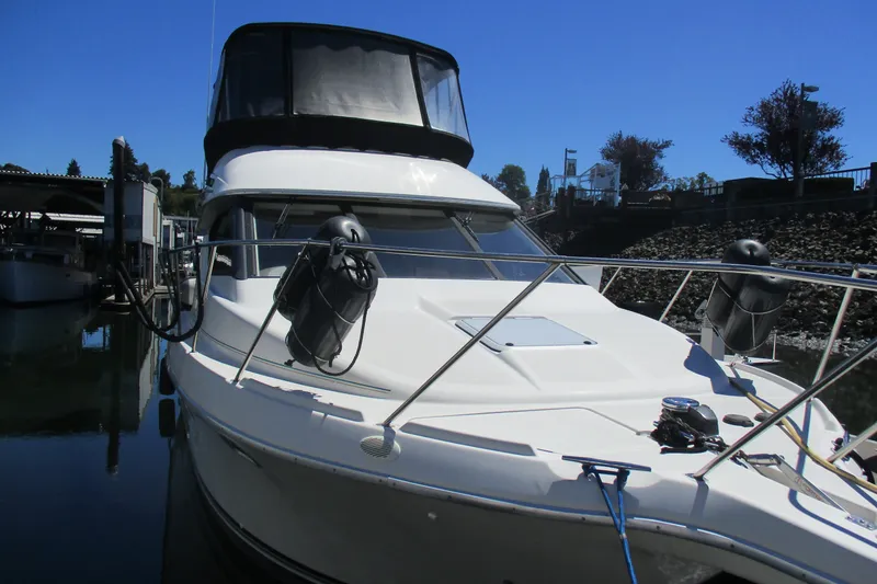 Slide: The Image of 1995 Bayliner 3258 Avanti boat docked, featuring sleek design and spacious cabin. - 7