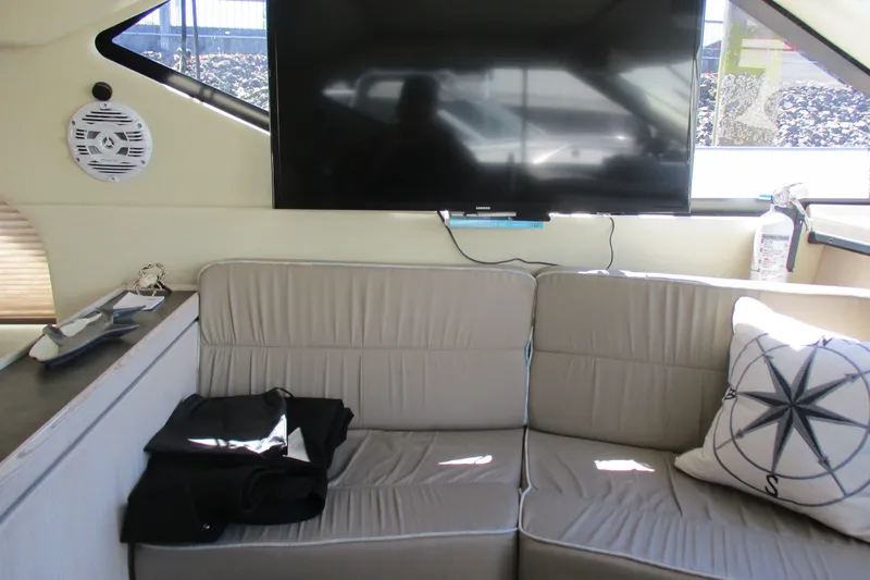 Slide: The Image of Interior of 1995 Bayliner 3258 Avanti with sofa, TV, and nautical-themed decor. - 32