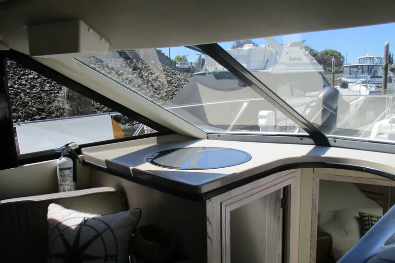 Slide: The Image of Interior view of 1995 Bayliner 3258 Avanti boat with modern dashboard and large windows. - 33