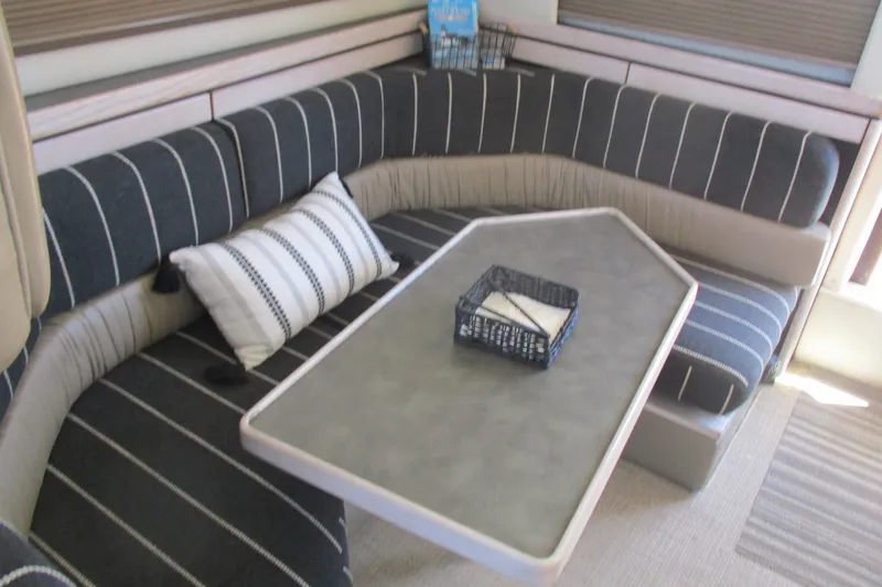 Slide: The Image of Interior of 1995 Bayliner 3258 Avanti with striped seating and a modern table. - 36