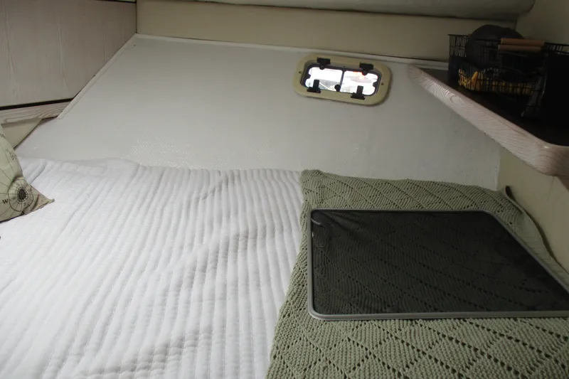 Slide: The Image of Cozy cabin interior of 1995 Bayliner 3258 Avanti with bed and small window. - 43