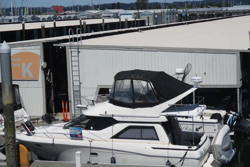 Slide: The Image of 1995 Bayliner 3258 Avanti docked at marina, South Dock K, with covered upper deck. - 0
