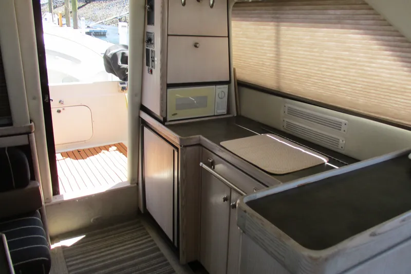Slide: The Image of Interior of 1995 Bayliner 3258 Avanti yacht with kitchenette and outdoor view. - 35
