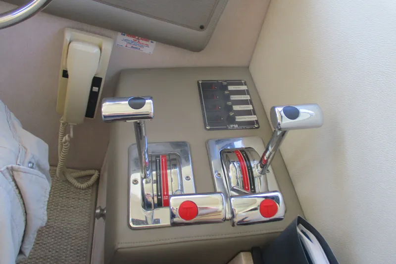 Slide: The Image of Control panel of a 1995 Bayliner 3258 Avanti boat with throttle levers and phone. - 29