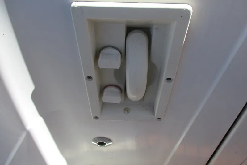 Slide: The Image of Close-up of a 1995 Bayliner 3258 Avanti boat component, featuring a white handle and knobs. - 13
