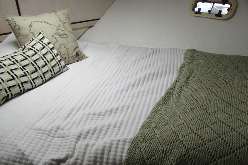 Slide: The Image of Cozy cabin interior of 1995 Bayliner 3258 Avanti with pillows and blanket. - 44