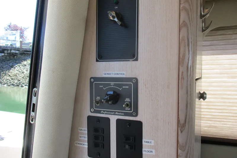 Slide: The Image of Control panel of a 1995 Bayliner 3258 Avanti boat, featuring genset controls. - 26