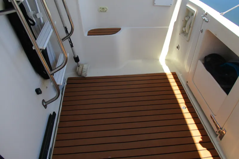 Slide: The Image of 1995 Bayliner 3258 Avanti boat deck with wooden flooring and storage compartments. - 15