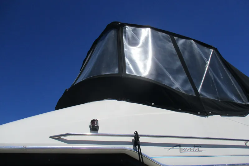 Slide: The Image of 1995 Bayliner 3258 Avanti boat with clear canopy against blue sky. - 5