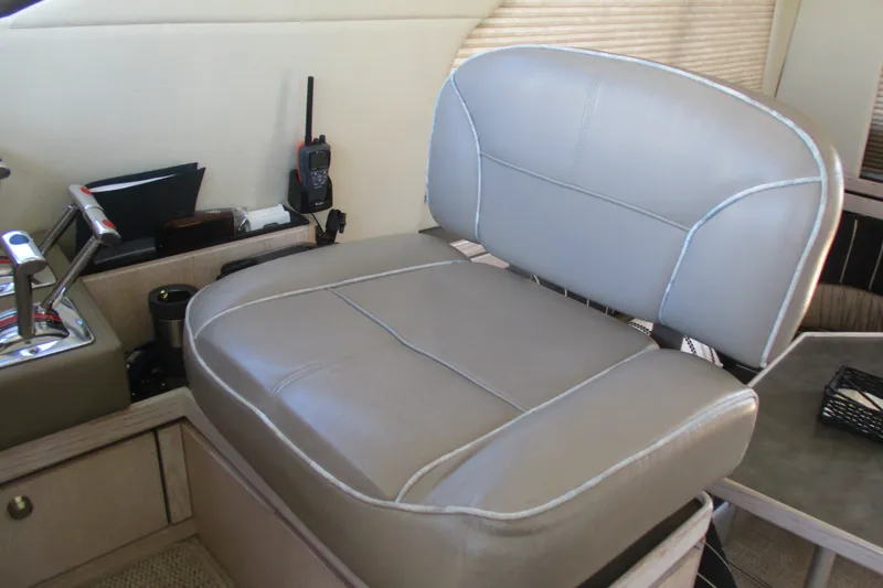 Slide: The Image of Captain's seat on 1995 Bayliner 3258 Avanti boat, featuring controls and radio equipment. - 52
