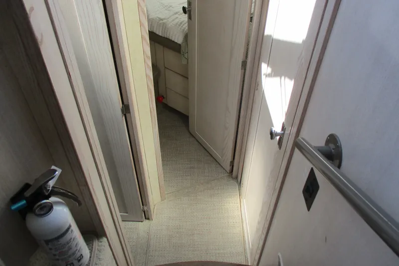 Slide: The Image of Interior hallway of 1995 Bayliner 3258 Avanti boat, featuring doors and a fire extinguisher. - 37