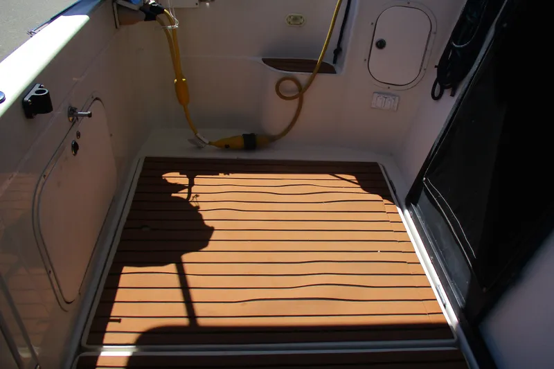 Slide: The Image of 1995 Bayliner 3258 Avanti boat deck with wood finish and utility connections. - 16