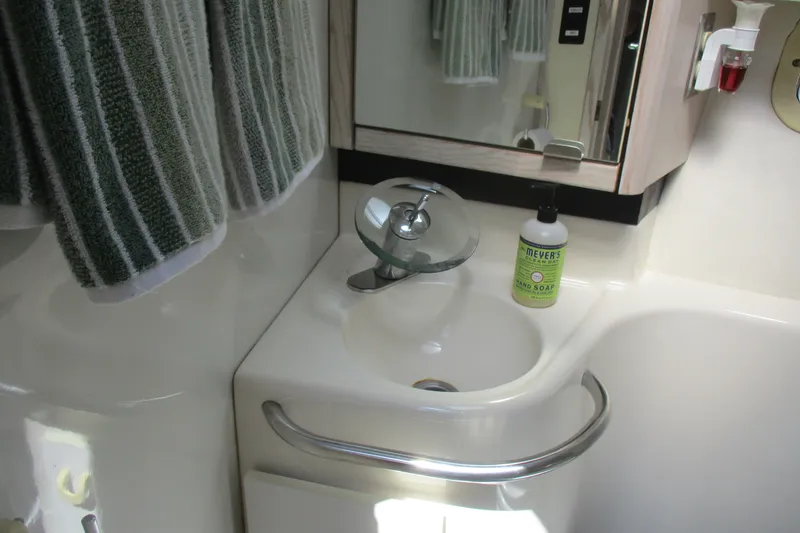 Slide: The Image of Bathroom sink area in a 1995 Bayliner 3258 Avanti boat with soap and towel. - 46