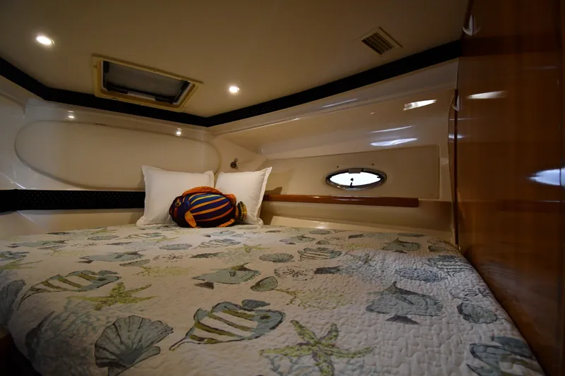Slide: The Image of Cozy cabin interior of 2002 Carver 350 Mariner with nautical-themed bedding. - 30