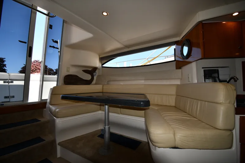 Slide: The Image of Interior of 2002 Carver 350 Mariner yacht with beige seating and table. - 40