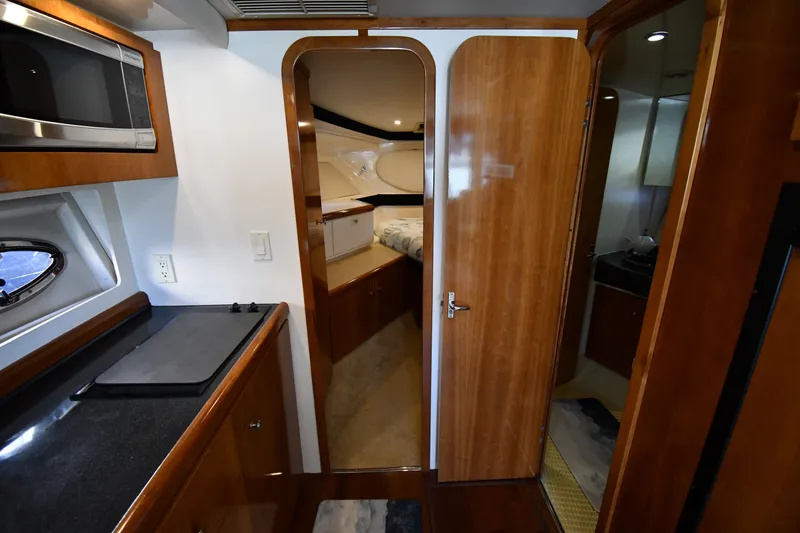 Slide: The Image of Interior of 2002 Carver 350 Mariner yacht with wood finishes and modern amenities. - 28