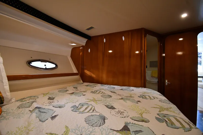 Slide: The Image of Cozy cabin interior of 2002 Carver 350 Mariner with nautical-themed bedding. - 33
