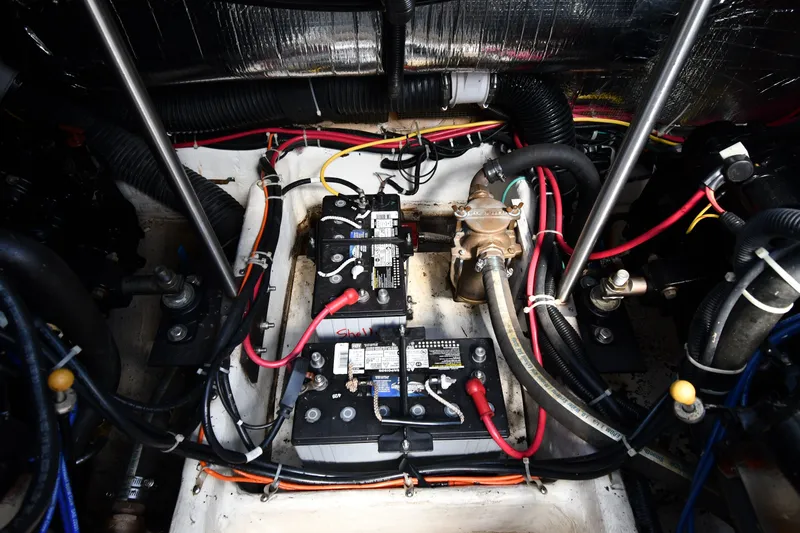 Slide: The Image of Engine compartment of a 2002 Carver 350 Mariner with batteries and wiring. - 52