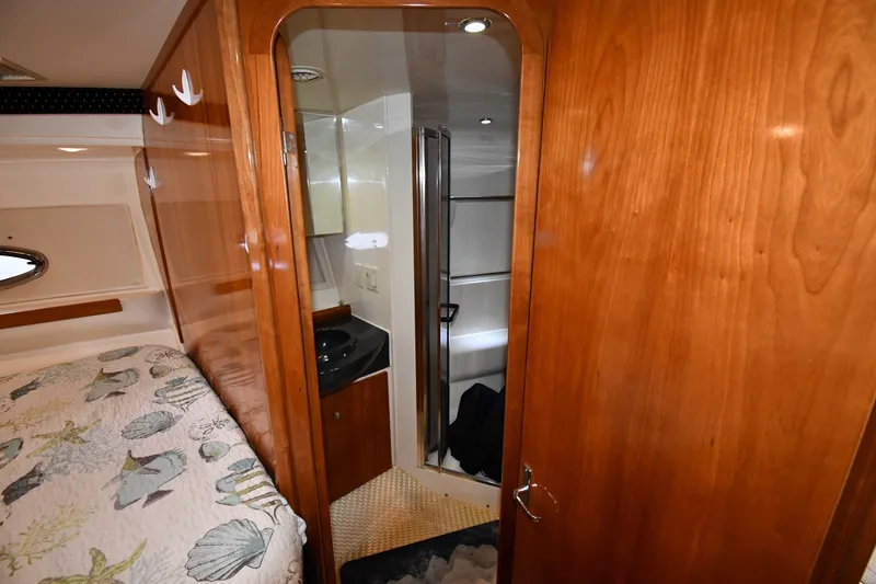Slide: The Image of Interior of 2002 Carver 350 Mariner yacht featuring a cozy cabin and bathroom. - 34