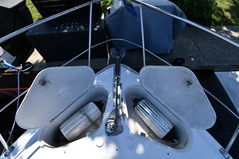 Slide: The Image of Bow view of a 2002 Carver 350 Mariner with open storage compartments. - 4