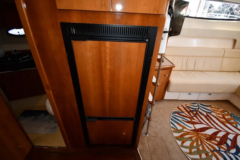 Slide: The Image of Interior of 2002 Carver 350 Mariner with wood cabinetry and colorful rug. - 46
