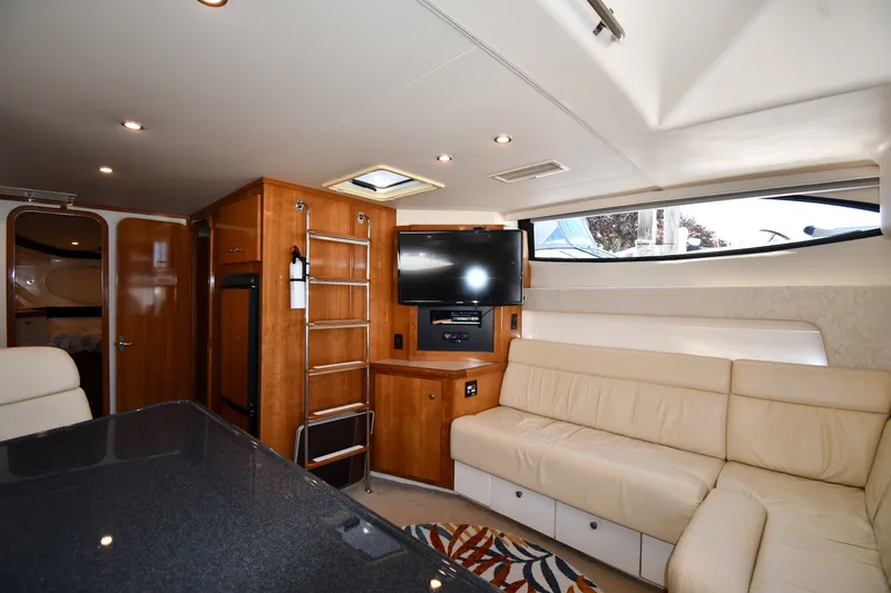 Slide: The Image of Interior of 2002 Carver 350 Mariner yacht with beige seating and mounted TV. - 38